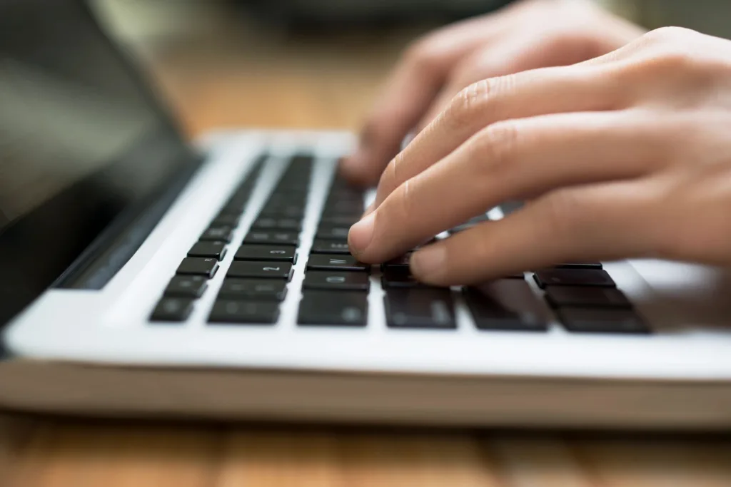 Person Typing on a laptop