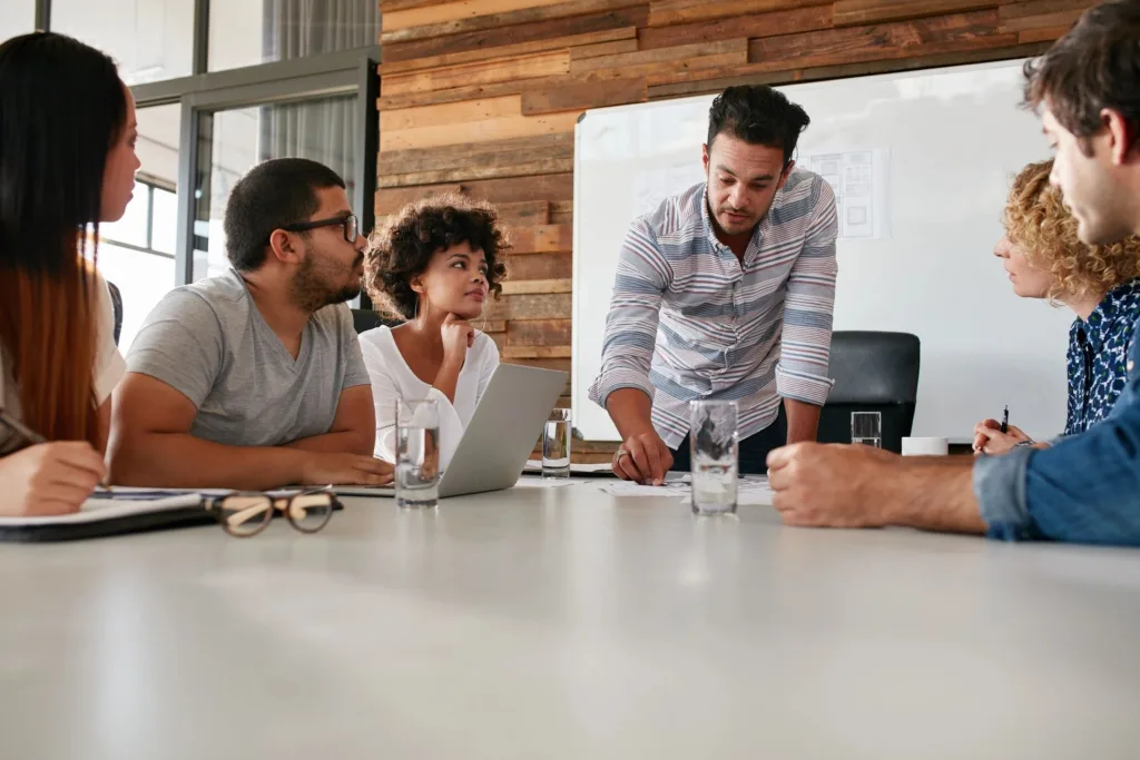men and women sitting at table at work